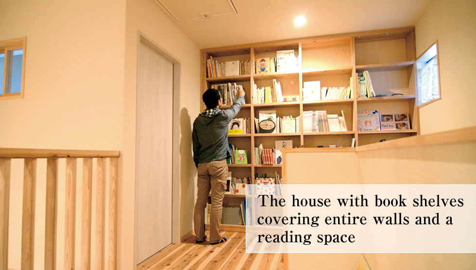 The house with book shelves covering entire walls and a reading space